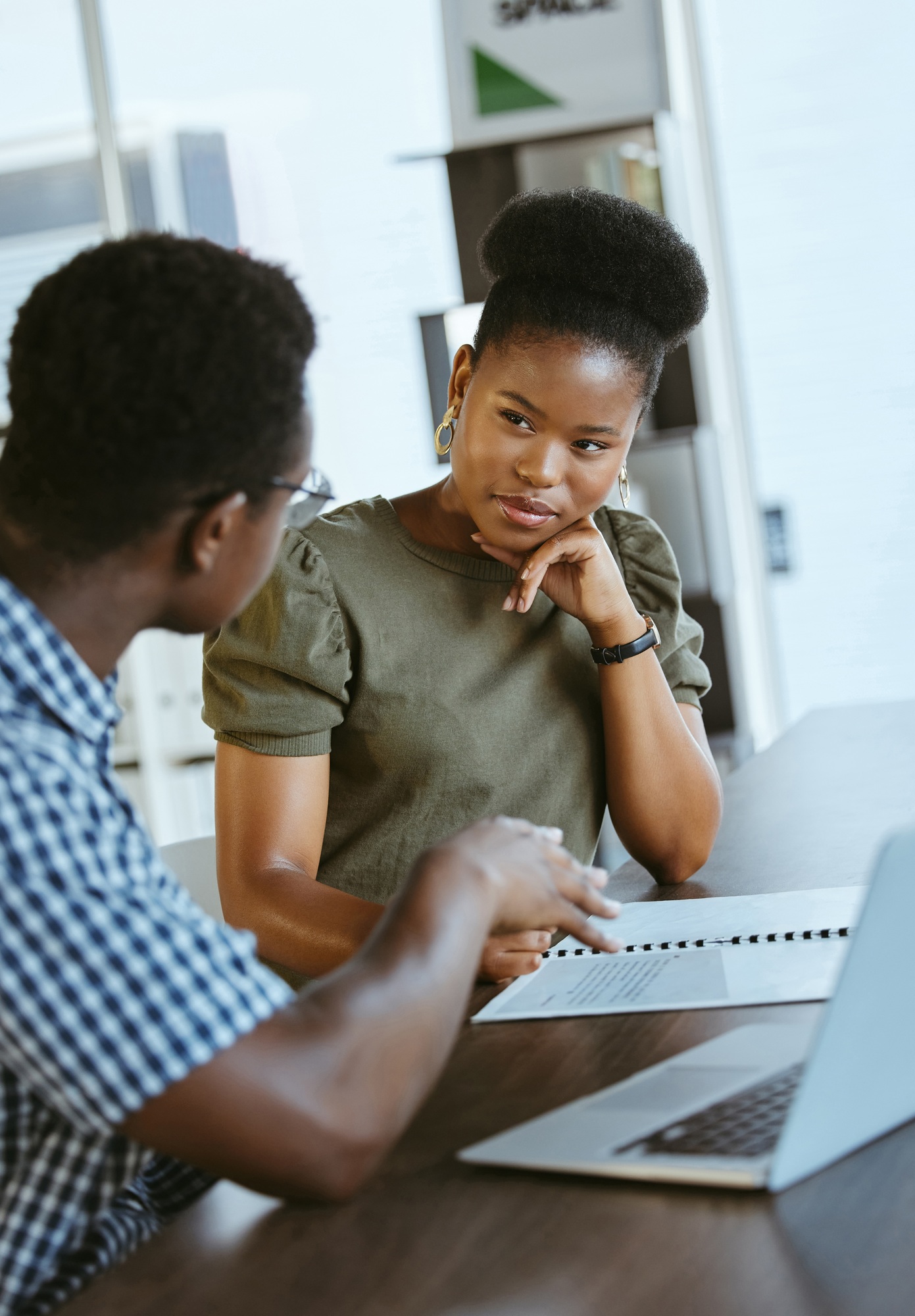 Two businesspeople having a meeting and looking at a report together at work. Businessman showing a